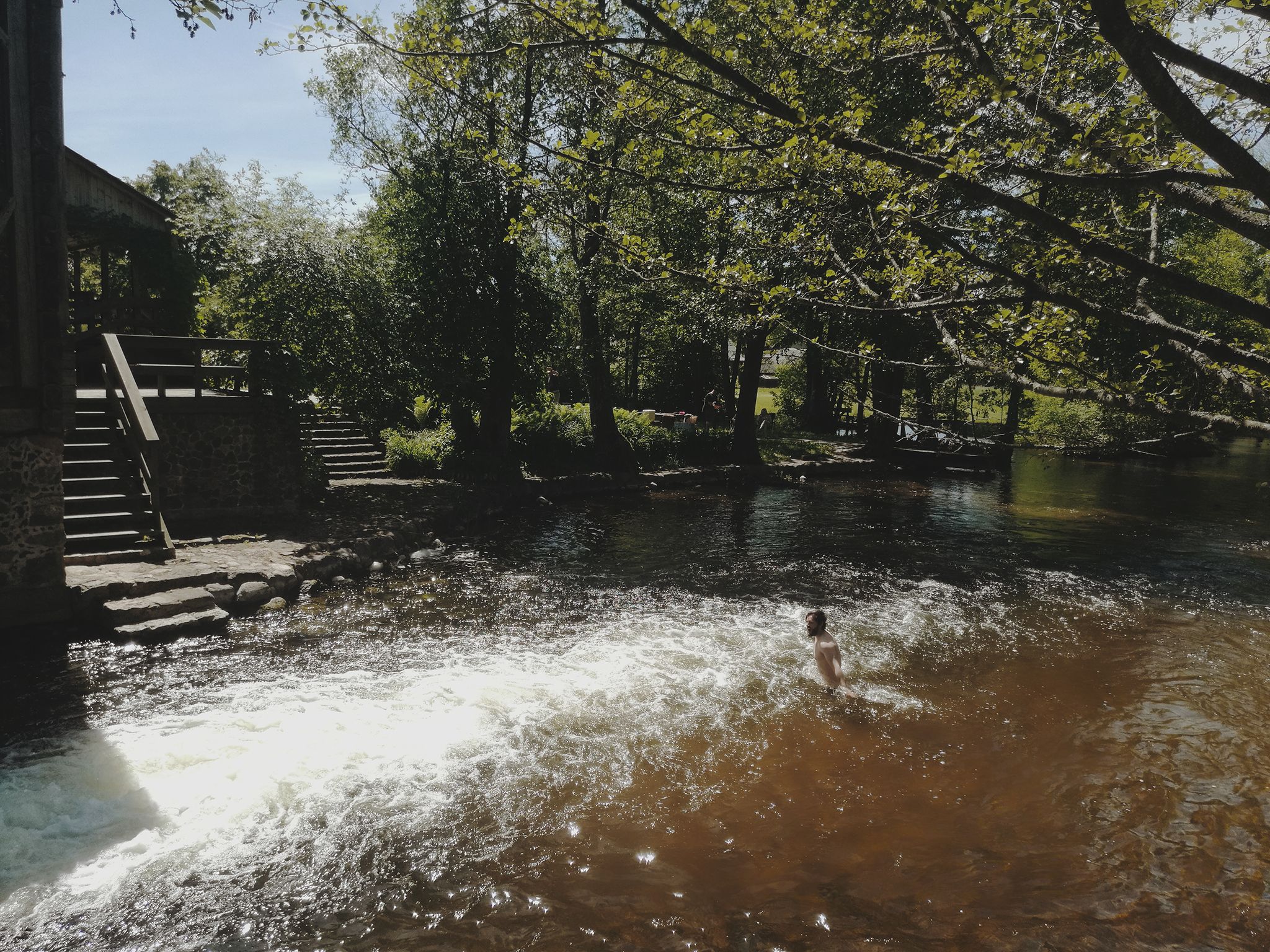 A Man Swimming Near Watermill