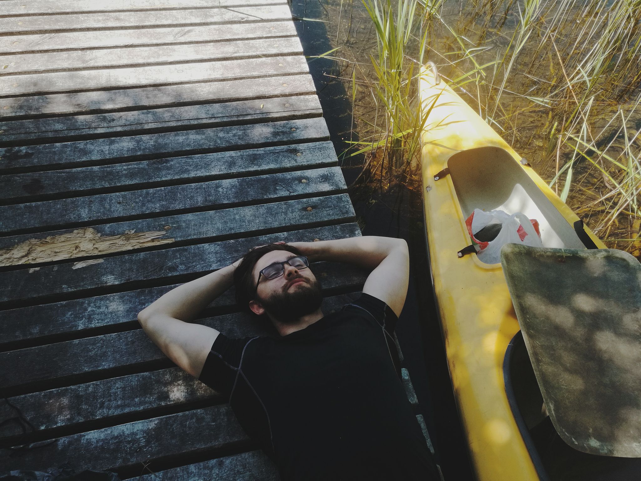 Man Resting Near Kayak