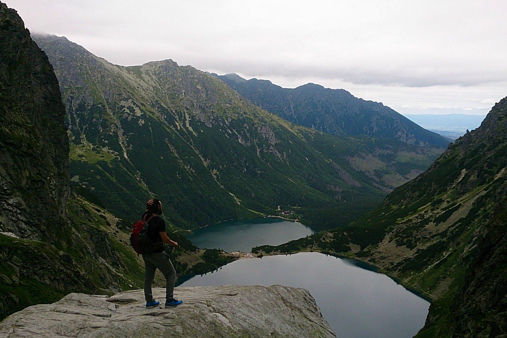 A Man Looking Over The Lakes