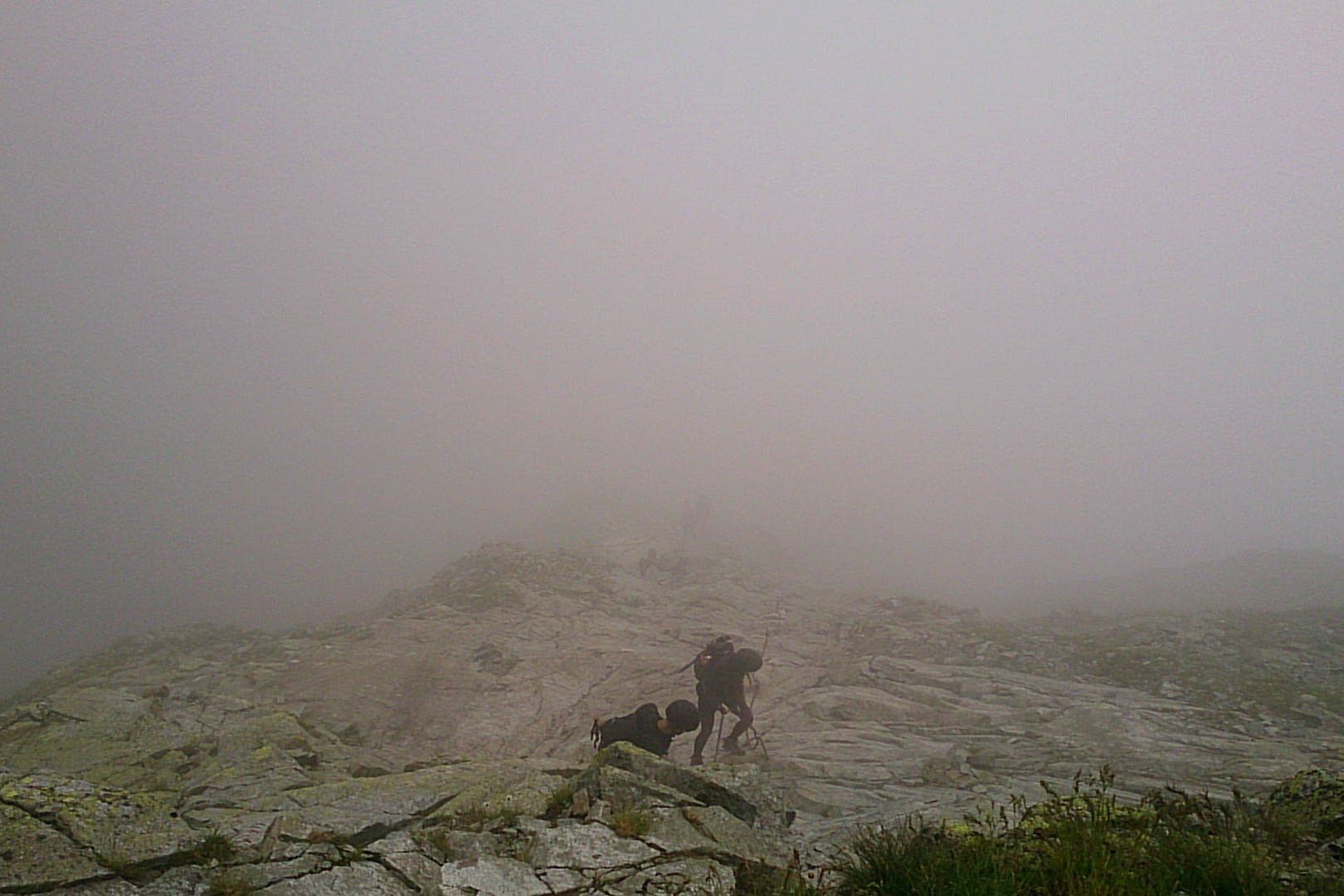 Hikers Climbing Rysy In A Fog