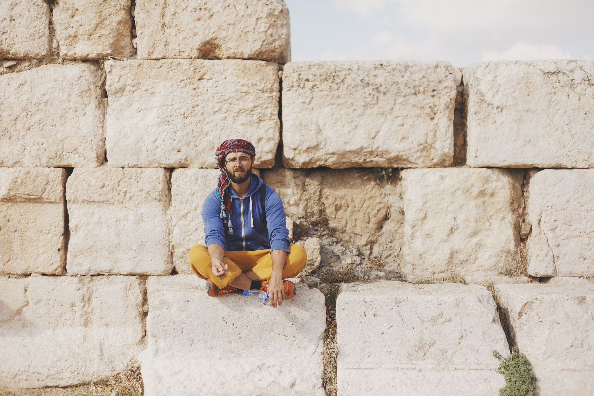 A Man Sitting Near The Wall